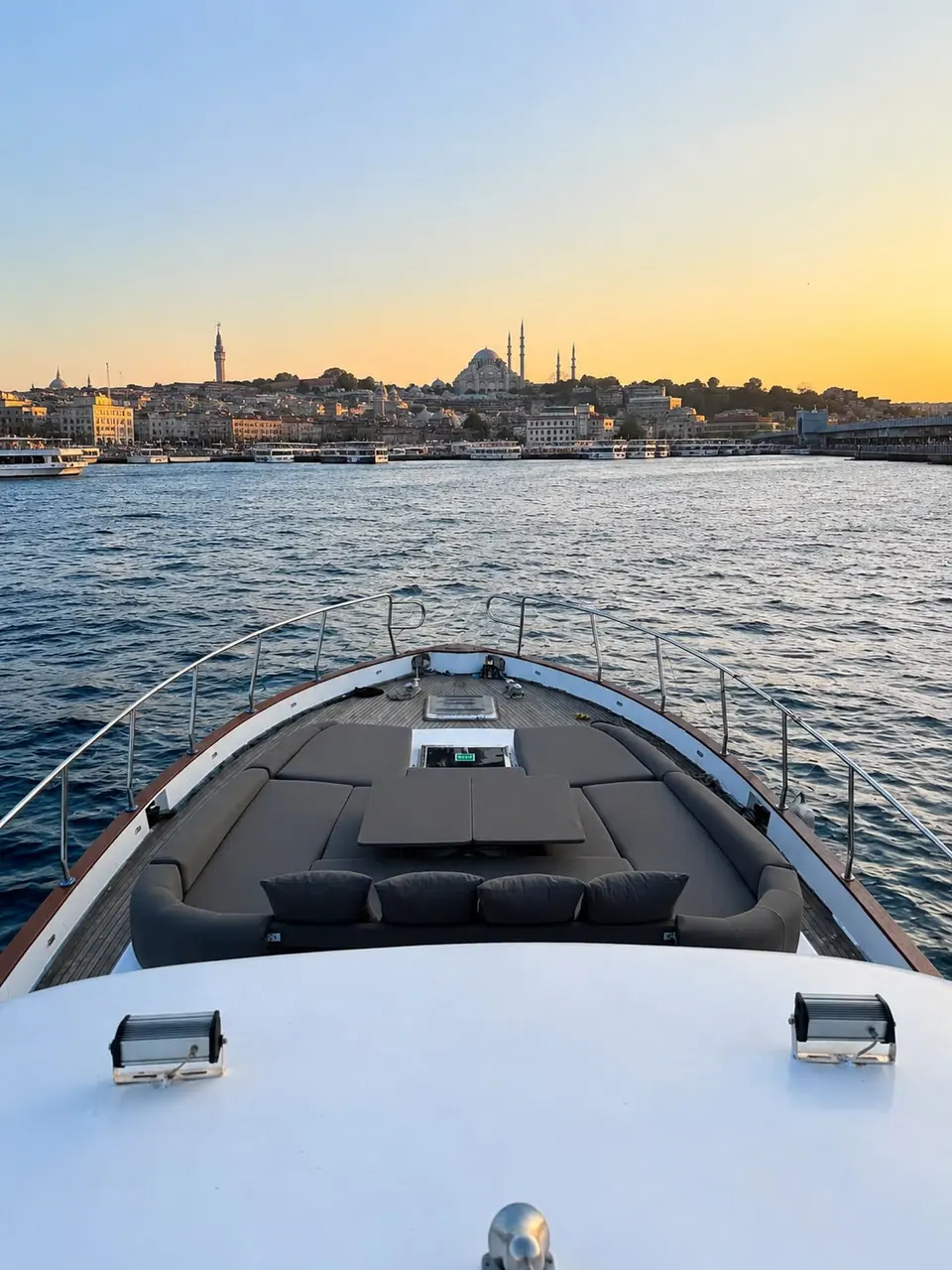 The bow of Hiluna facing the old city skyline at sunset